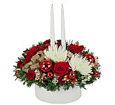 Premium holiday floral centerpiece with two white candles, in white, red, and gold with lush roses.