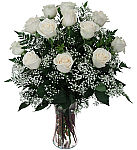 Glass vase arrangement of 12 white roses with baby's breath. White roses symbolize purity, innocence and love.