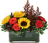 Rectangular vase of sunflowers, roses and carnations.