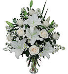 At a time of loss send our Peace floral arrangement to the family home, featuring white lilies, roses and asters all artistically arranged. Professional florist delivery across Canada.