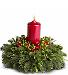 Traditional Christmas centerpiece with red pillar candle, berries Christmas holly, cedar and fir greens. Same day delivery across Canada.
