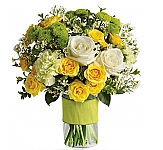 This dazzling bouquet includes white roses, yellow spray roses, green carnations, green button spray chrysanthemums and white waxflower accented with assorted greenery. Delivered in a glass cylinder vase.