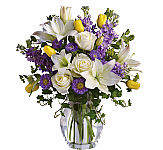 Serene crème roses, yellow tulips, white asiatic lilies, lavender stock and Matsumoto asters are perfectly arranged with spring's freshest greenery and delivered in a lovely clear glass vase.