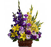 A lovely display of fresh blooms in yellow, purple and lavender shades is equally suitable for a family home or the funeral service. Teleflora delivery across Canada with Canada Flowers.