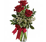 A beautiful glass vase arrangement of 3 red roses.
