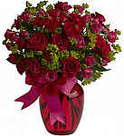 Teleflora's You 'n Me ruby red and hot pink flowers expertly arranged in a pretty red vase.