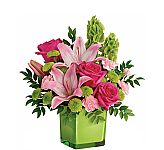 A glass vase holds a pretty arrangement of lavender, pink and purple blooms for Mother's Day.