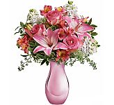 A beautiful pink vase is arranged with pink roses, lilies and alstroemrias, plus white stock and complementary greens. Flowers delivered across Canada by Canada Flowers.