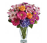 Gorgeous arrangement of pink lilies, fuchsia Gerbera, blue hydrangea, pink alstroemeria, orange roses and mauve daisies.