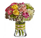 Gorgeous green hydrangea, yellow and light pink roses, pink spray roses and mini gerberas, light yellow carnations and green button spray chrysanthemums are delivered in a pretty gathering vase. Not just any vase, of course, this one's accessorized with a chartreuse taffeta ribbon and pink raffia.