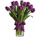​Spring's loveliest and most vibrant purple tulips are delivered in a special vase that's wrapped up with a purple satin ribbon.