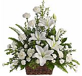 White blooms are arranged in a natural wicker basket with assorted greenery in a traditional sympathy design. Same day delivery across Canada. We are Canada Flowers, Canada's National Florist.